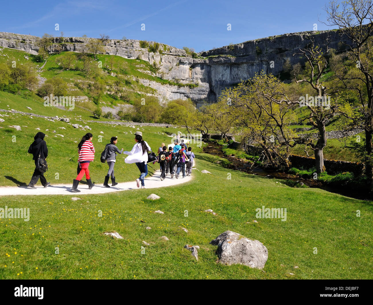 Excited school children on the approach to Malham Cove, Yorkshire Dales National Park, England Stock Photo