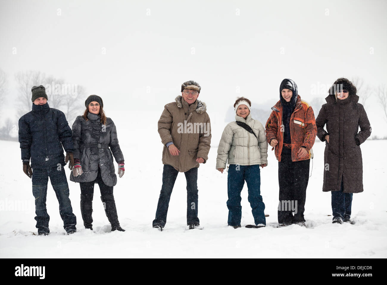 Group of happy people enjoying winter in snow. Stock Photo