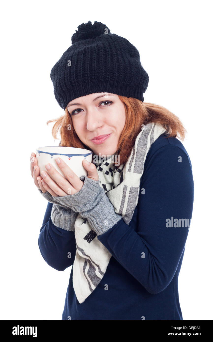 Happy woman in winter hat enjoying hot drink, isolated on white background. Stock Photo