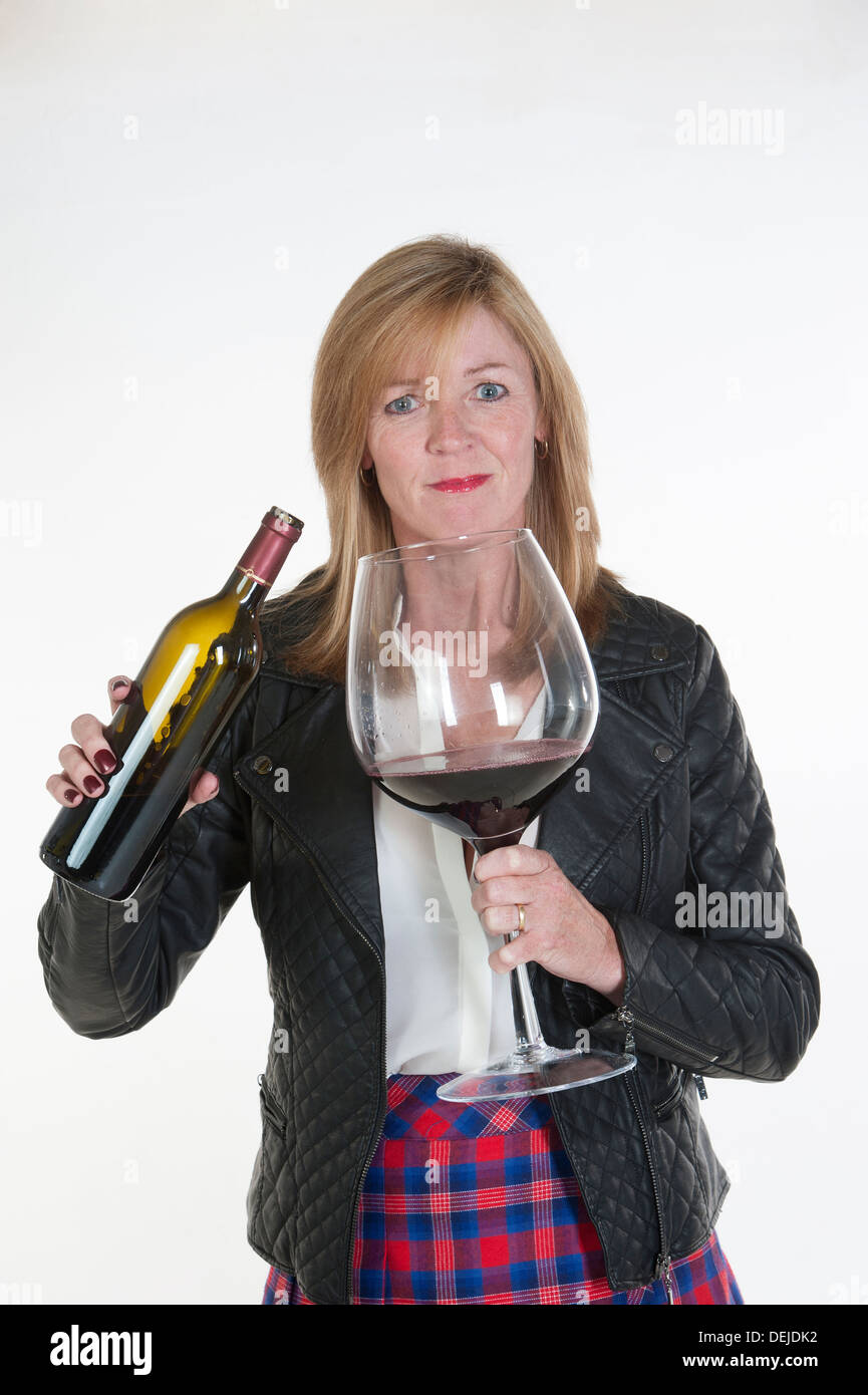 Middle aged woman drinking wine bottle hires stock photography and