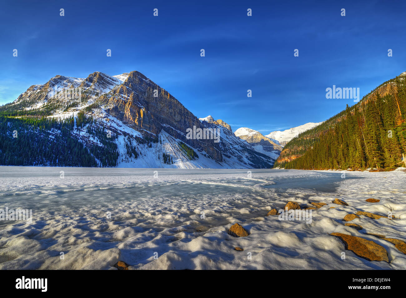 Frozen Lake Louise in morning sun in Banff National Park, Alberta ...