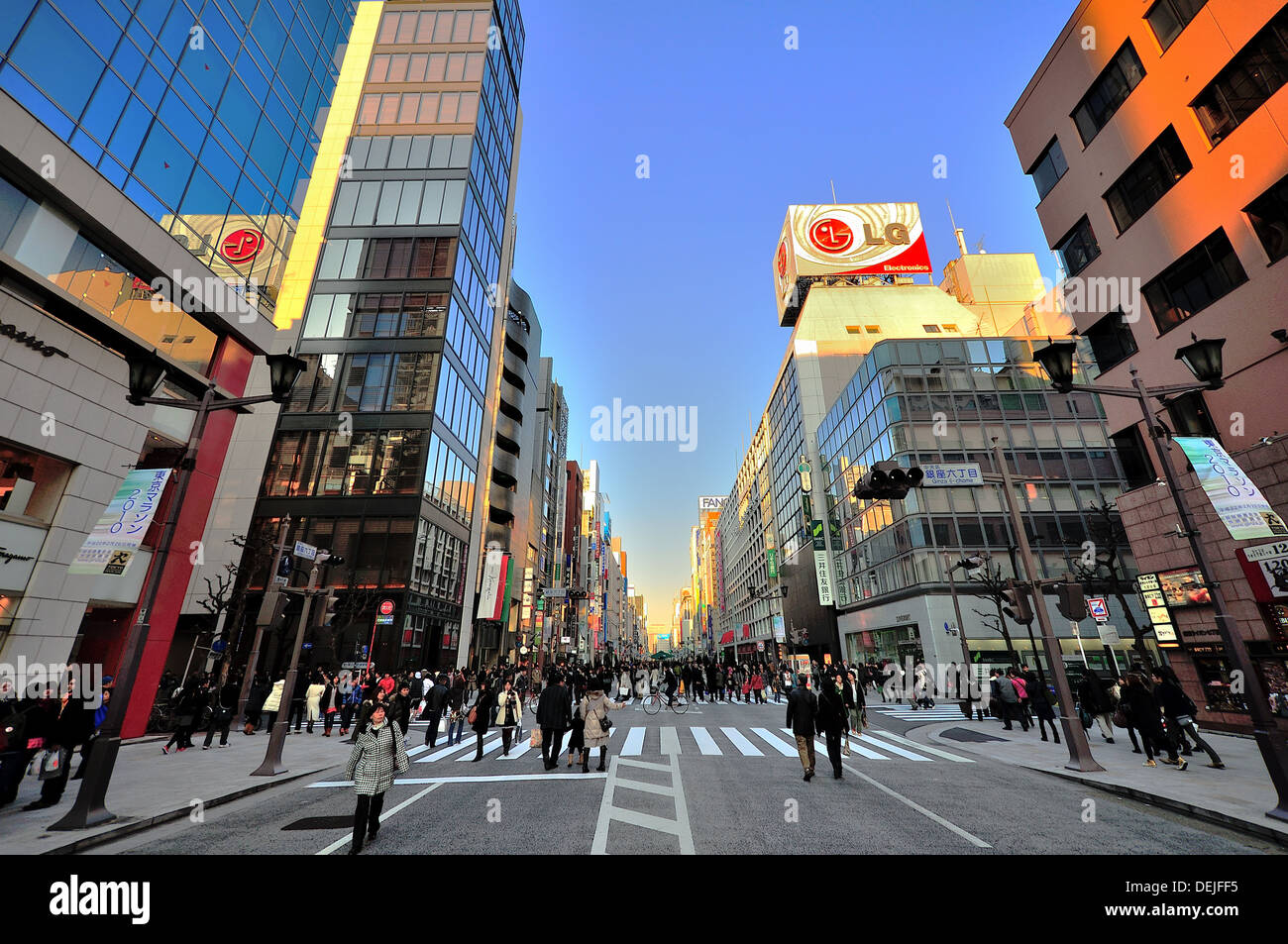 Shoppers and walkers enjoy a beautiful car-free day in the up-scale shopping area of Ginza, Tokyo, Japan Stock Photo