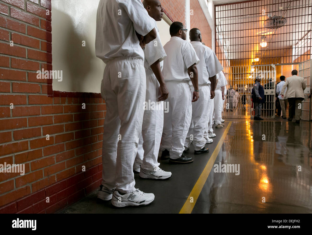 Male inmates at the Darrington Unit near Houston, Texas line up inside prison to attend event Stock Photo