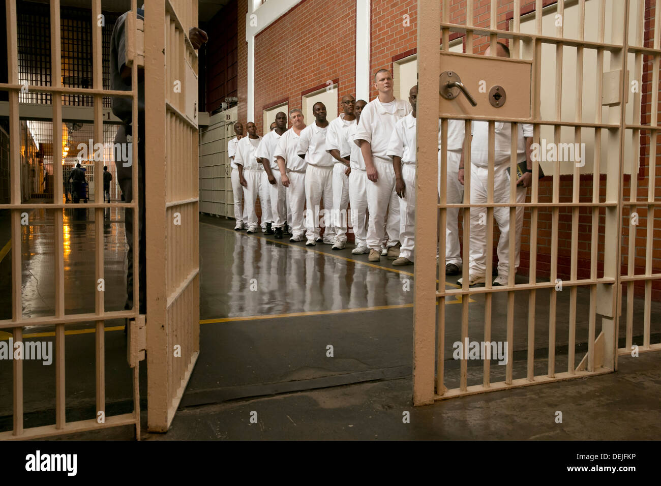 Male inmates at the Darrington Unit near Houston, Texas line up inside prison to attend event Stock Photo