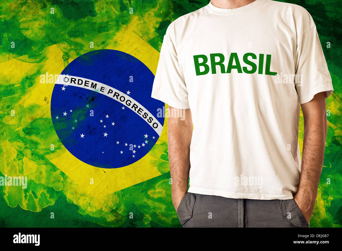 Man in white shirt with title BRASIL, Brasilian flag in background Stock Photo