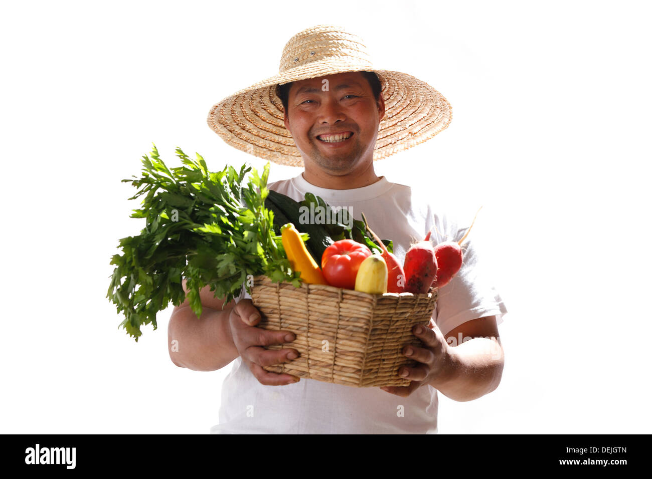 Farmer holding basket of vegetables Stock Photo - Alamy