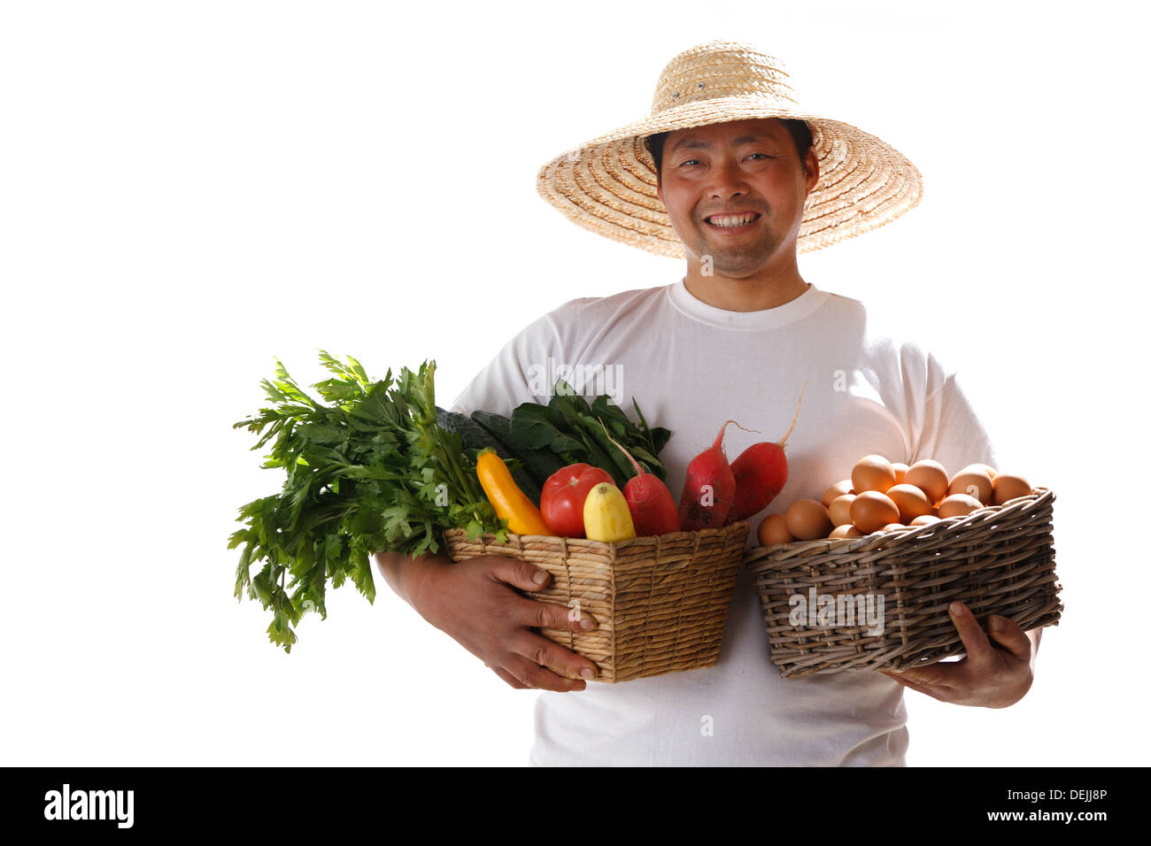 Farmer holding basket of vegetables Stock Photo - Alamy