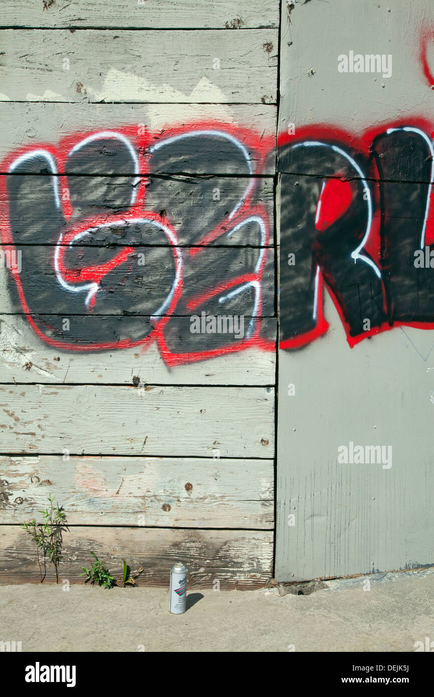 Spray paint can and graffiti under pedestrian bridge along the Glendale Narrows, Los Anglees River, California Stock Photo
