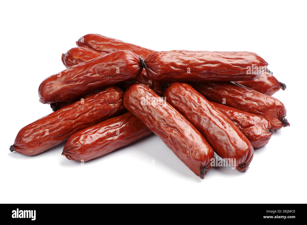 Small smoked sausages on a white background Stock Photo