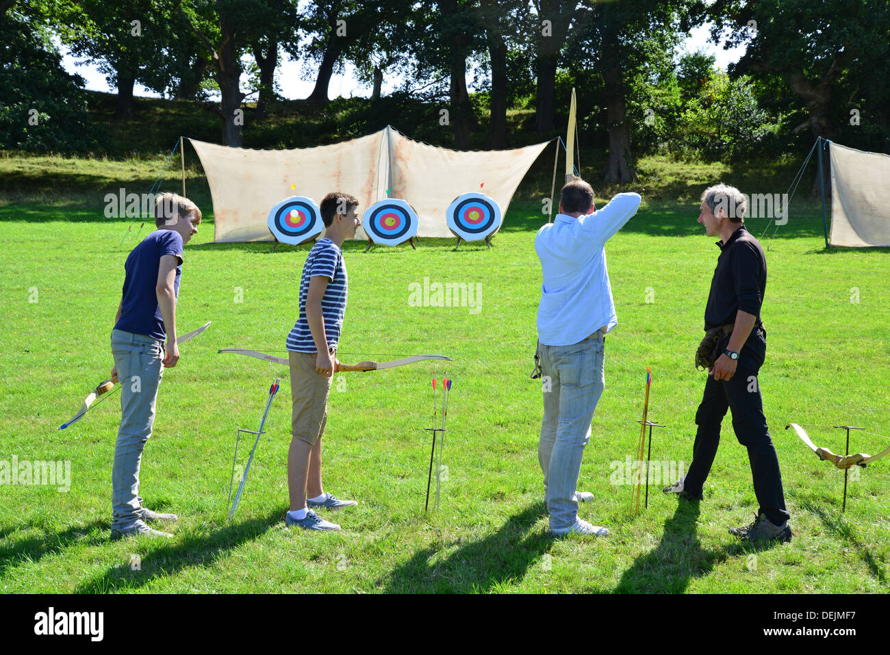 Young boys trying archery at The Dunster Agricultural Show, Dunster Castle Lawns, Dunster, Somerset, England, United Kingdom Stock Photo