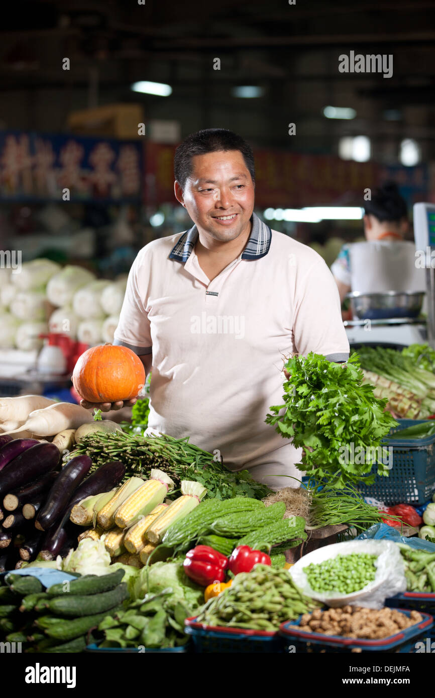 Farmer selling vegetables in food market Stock Photo - Alamy