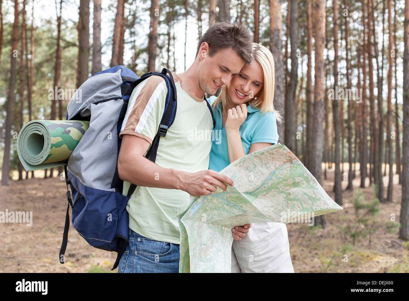 Young hiking couple reading map forest Stock Photo