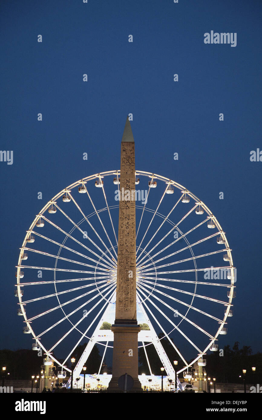 France. Paris. The night view of 3200 years old obelisk from Luxor in Palace de la Concorde with ferry wheel in the background. Stock Photo