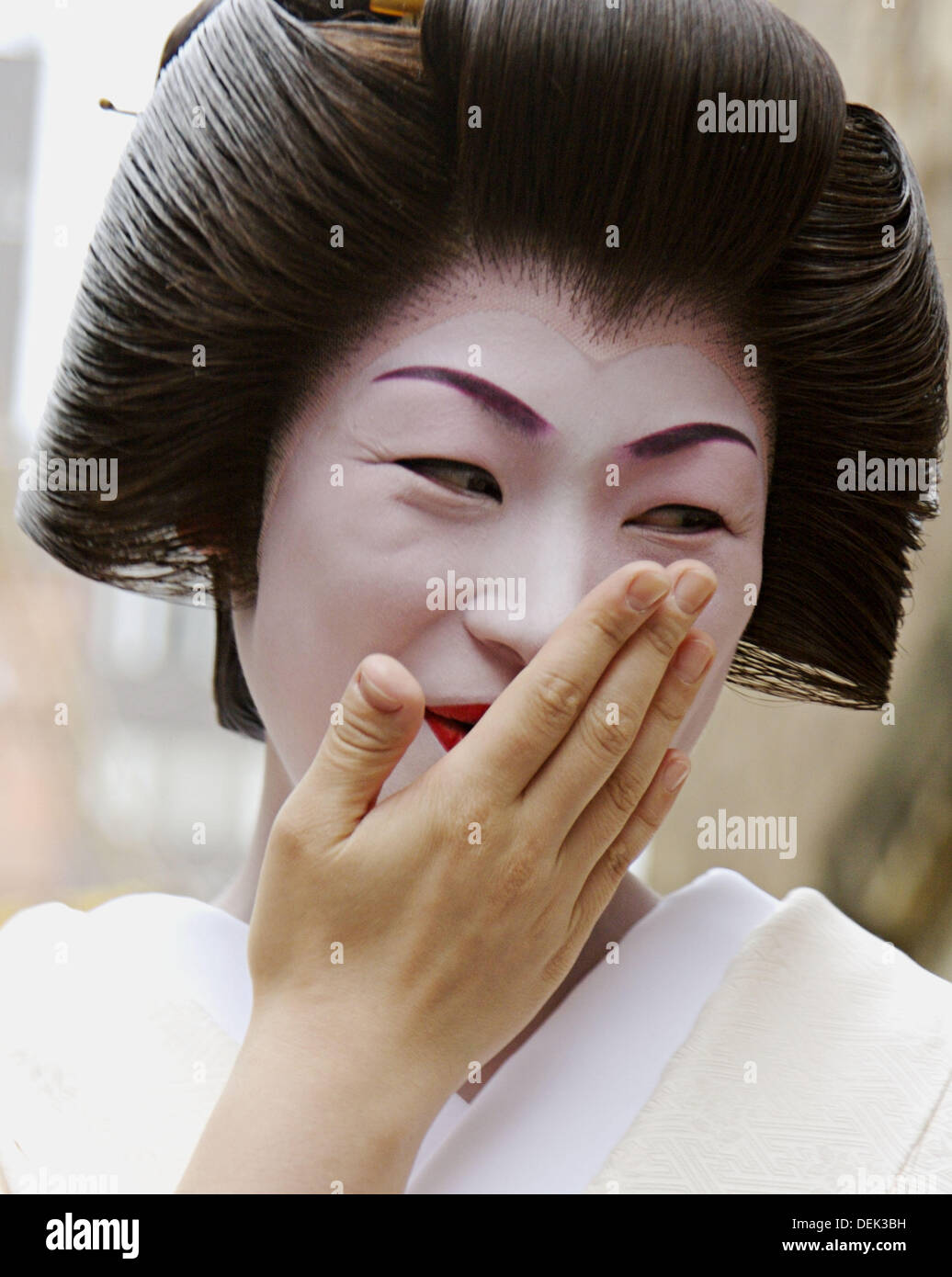Japanese woman covering mouth laughing hires stock photography and