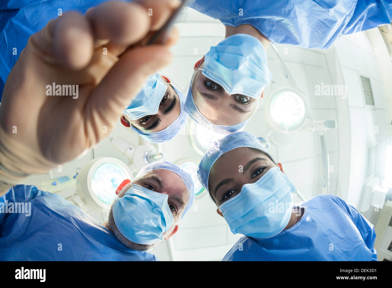 Interracial male female medical hospital doctors surgeons surgical team operating theater performing surgery on a patient Stock Photo