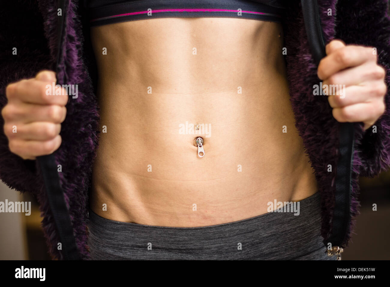 Close up on an athletic woman's toned abs Stock Photo