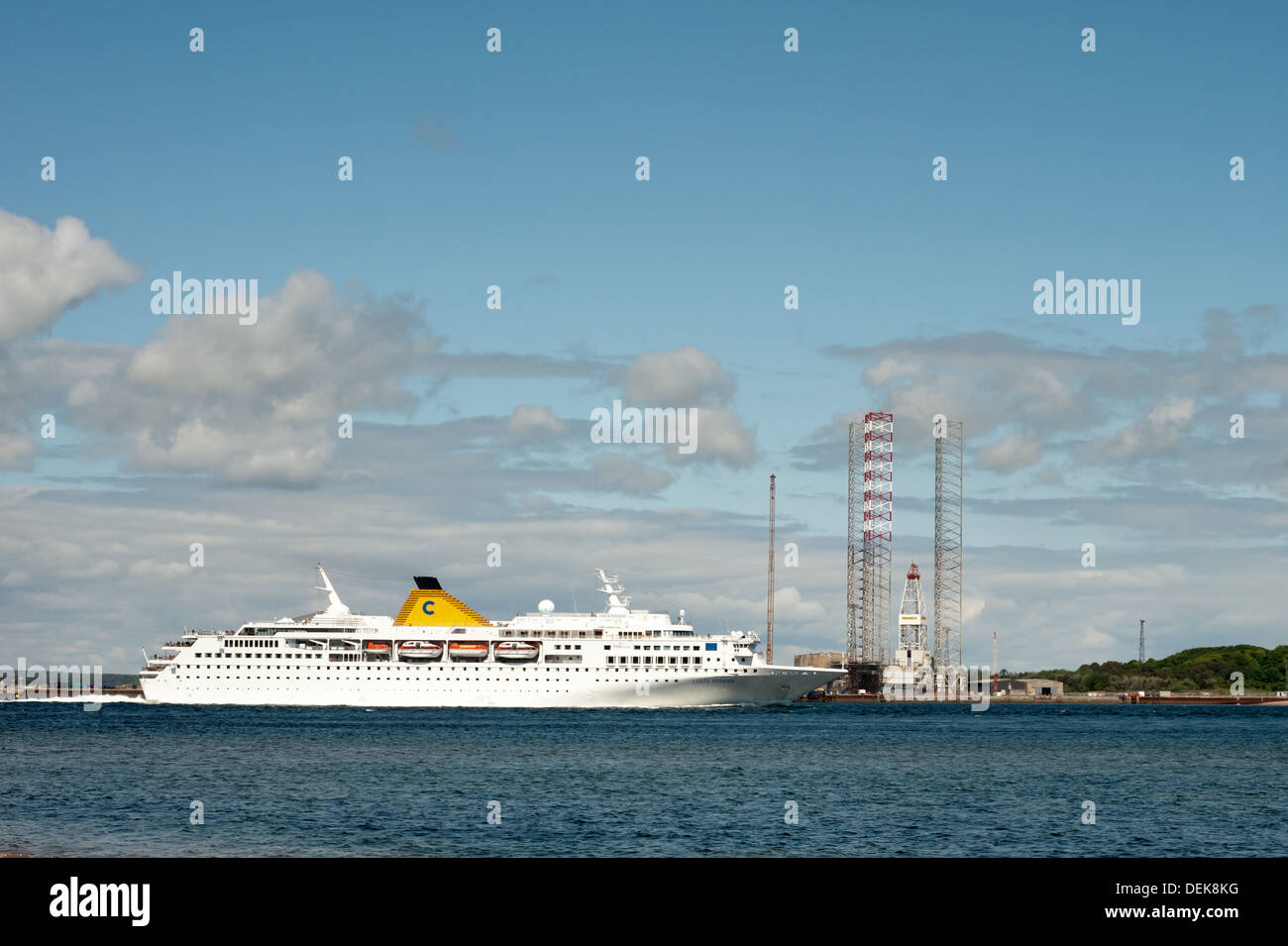 Cruise Liner passing the Rigs Stock Photo