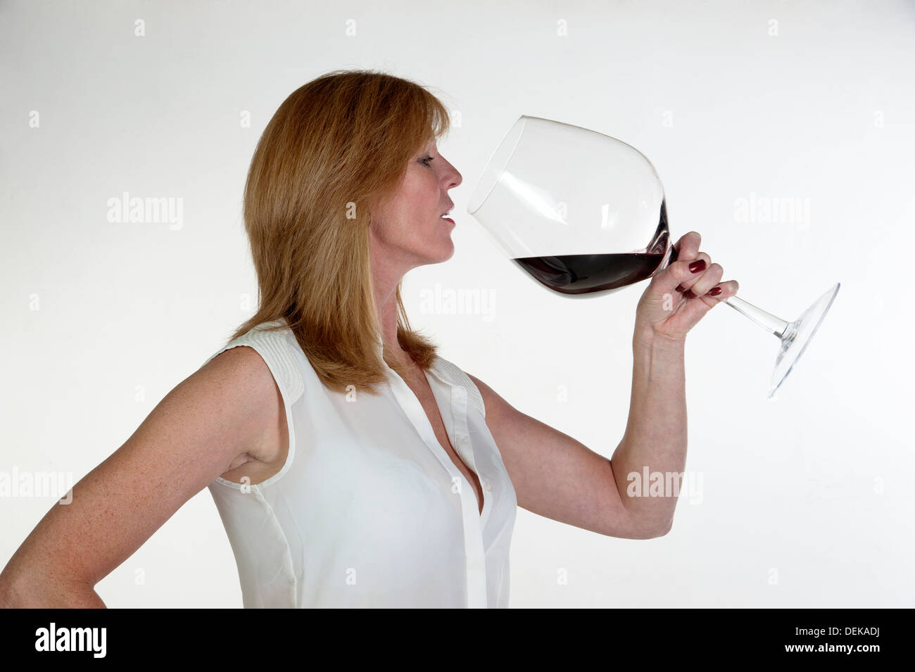 https://c8.alamy.com/comp/DEKADJ/woman-tasting-from-a-very-large-glass-of-red-wine-DEKADJ.jpg