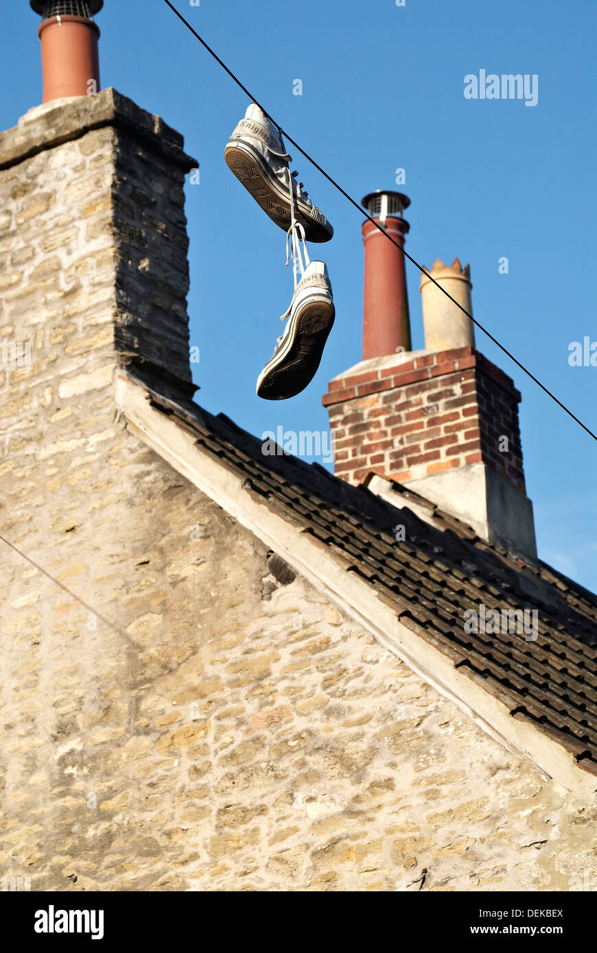 Shoes hanging from telephone wires,drug gang boundary marker Stock Photo