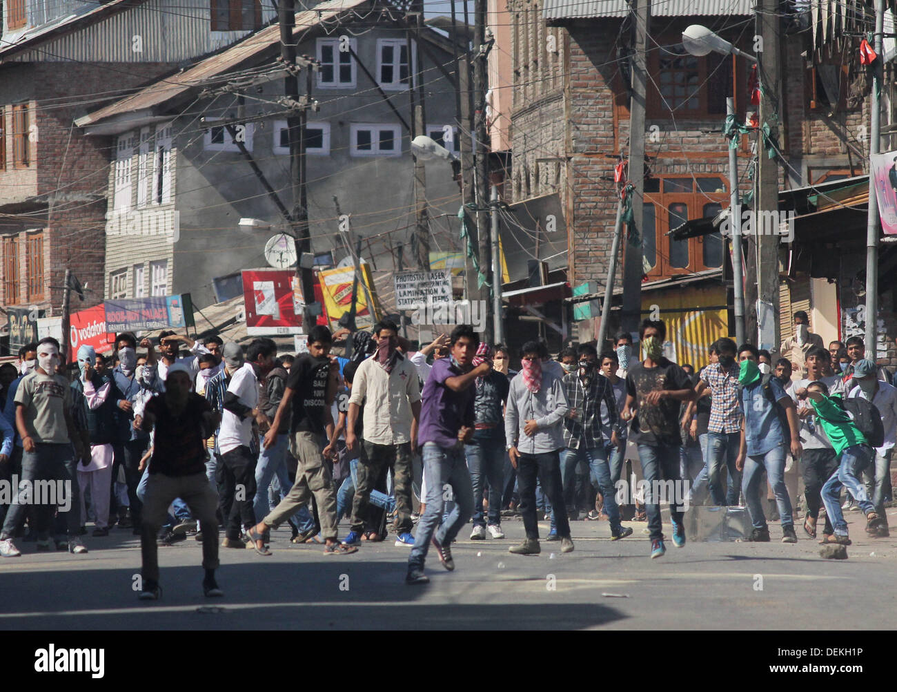 Sept. 20, 2013 - Kashmiri protesters throw stones toward Indian policemen during a protest in Srinagar,the summer capital of indian kashmir on 20/9/2013,Protests broke out in various parts of Kashmir Valley Friday against the killing of five persons by CRPF in south Kashmirâ€™s Gagren village.A march was carried out in old cityâ€™s Khanyar locality by dozens of All Party Hurriyat Conference (M) activists who chanted anti-India and pro-freedom slogans. The procession was led by Mohammad Shafi Khan who demanded action against the perpetrators of Shopian incident.As the activists marched towards  Stock Photo