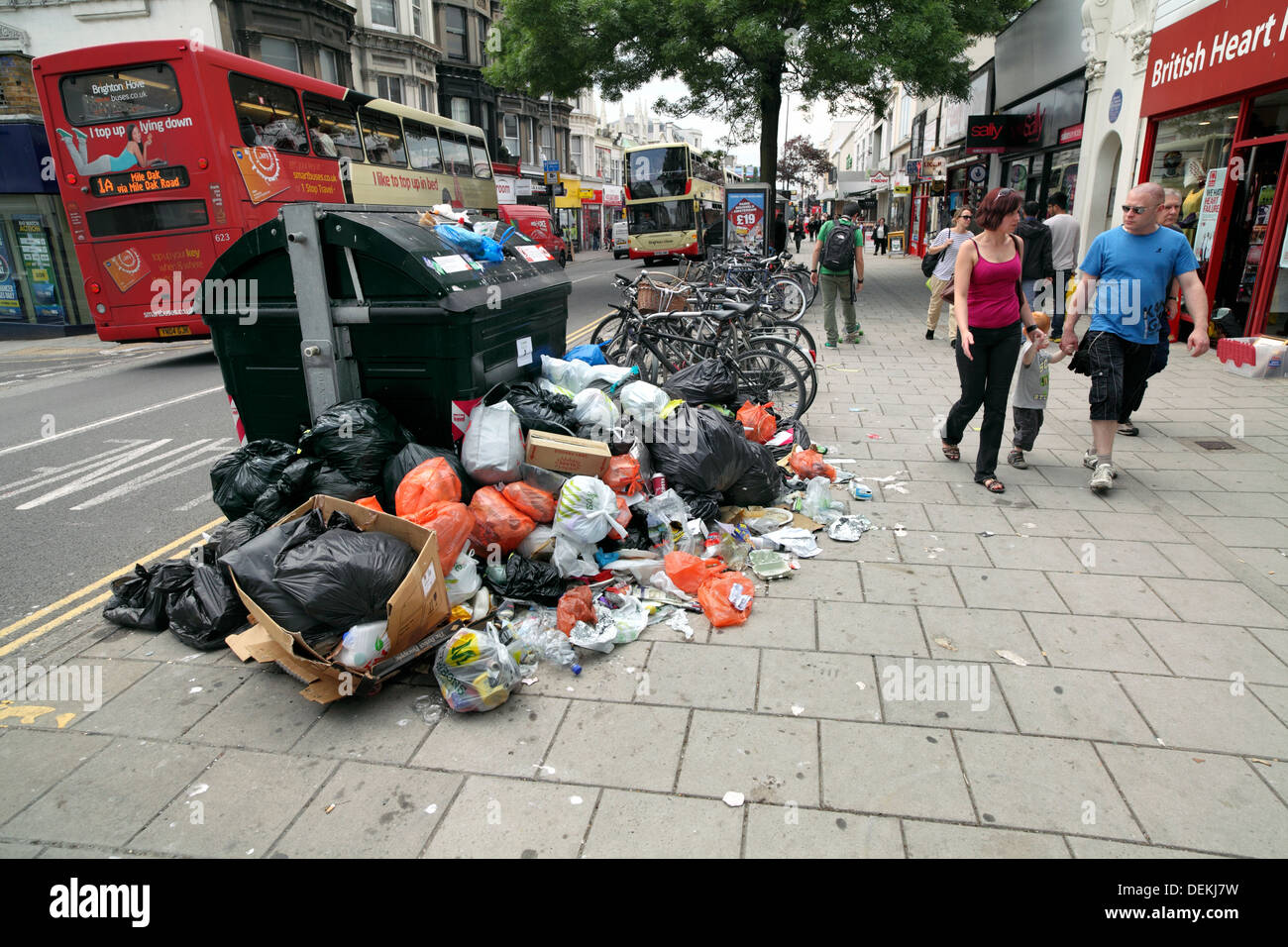 Rubbish piled around an overflowing skip of litter, Brighton. Stock Photo