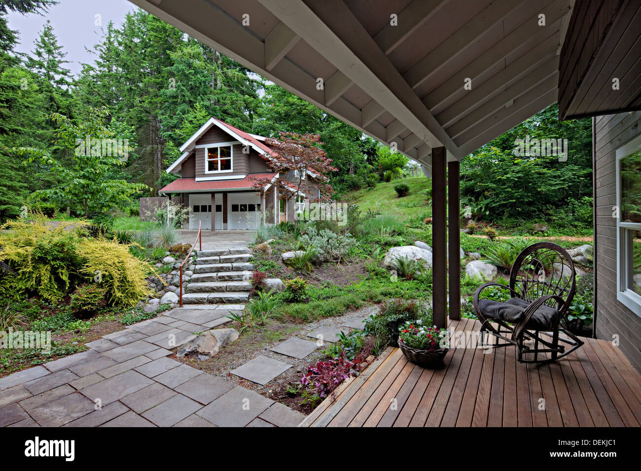 Rocking chair on porch overlooking garden Stock Photo Alamy