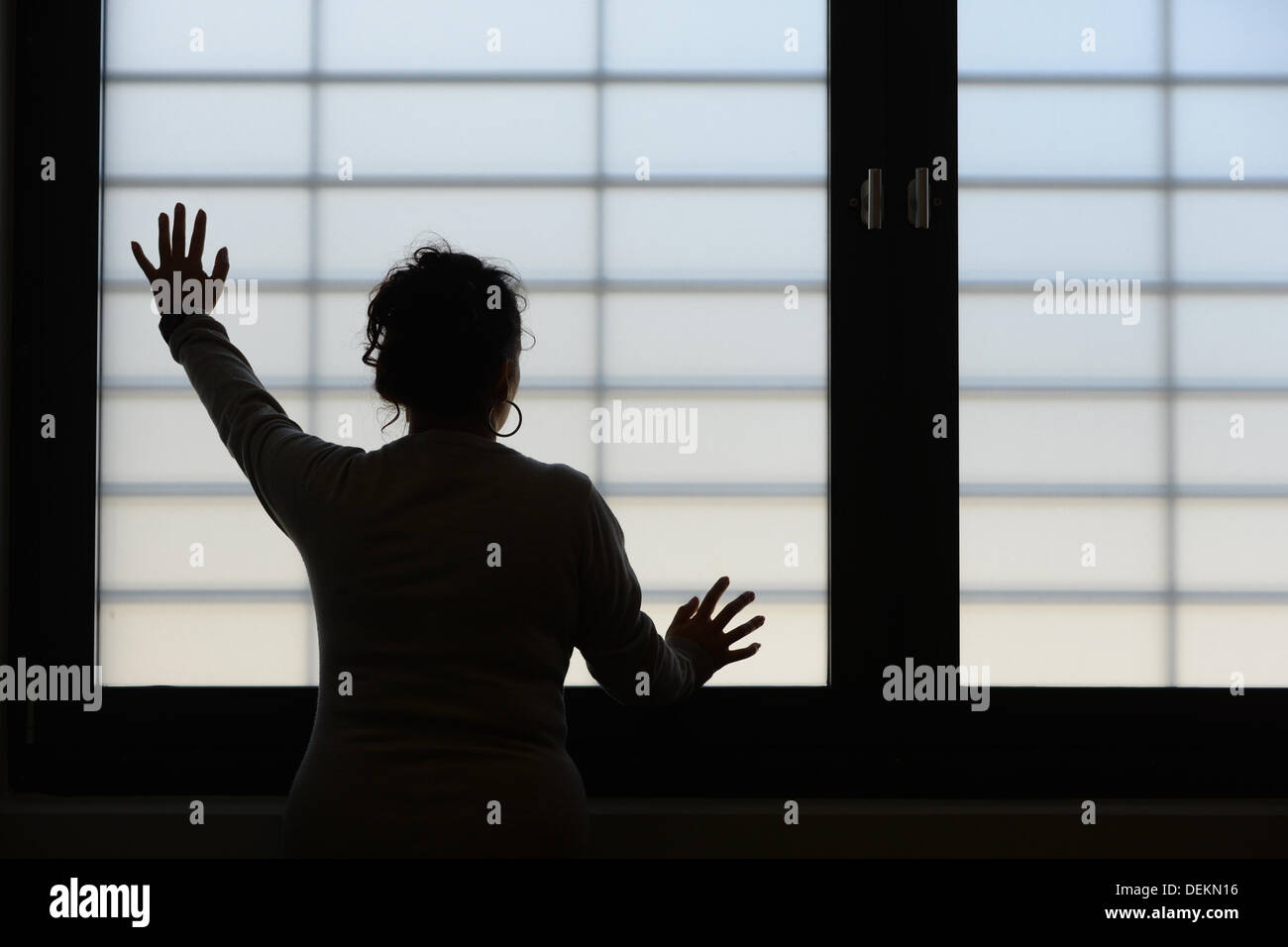 Ravensburg, Germany. 19th Sep, 2013. A female inmate poses at a barred window in the new build of the prison in Ravensburg, Germany, 19 September 2013. Photo: Felix Kaestle/dpa/Alamy Live News Stock Photo