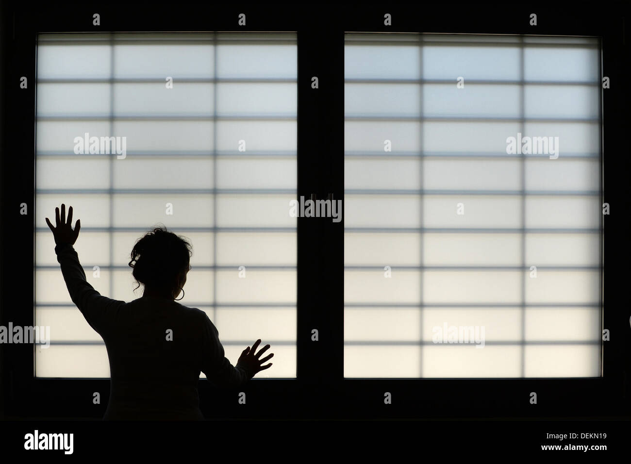 Ravensburg, Germany. 19th Sep, 2013. A female inmate poses at a barred window in the new build of the prison in Ravensburg, Germany, 19 September 2013. Photo: Felix Kaestle/dpa/Alamy Live News Stock Photo