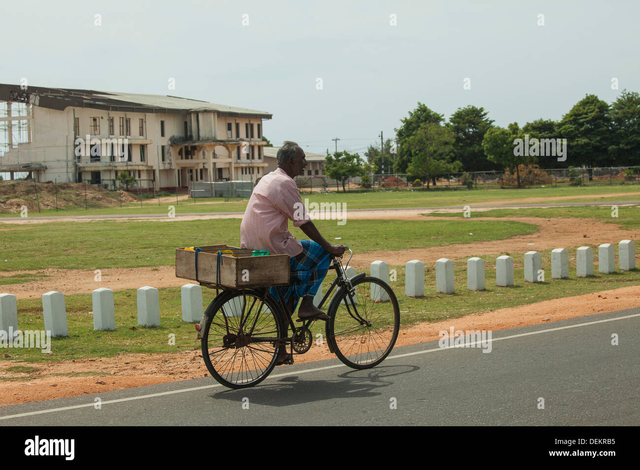 Man wearing sarong on a bike in Sri Lanka Stock Photo