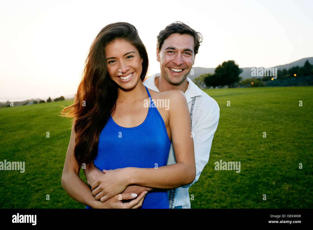Couple hugging in park Stock Photo - Alamy