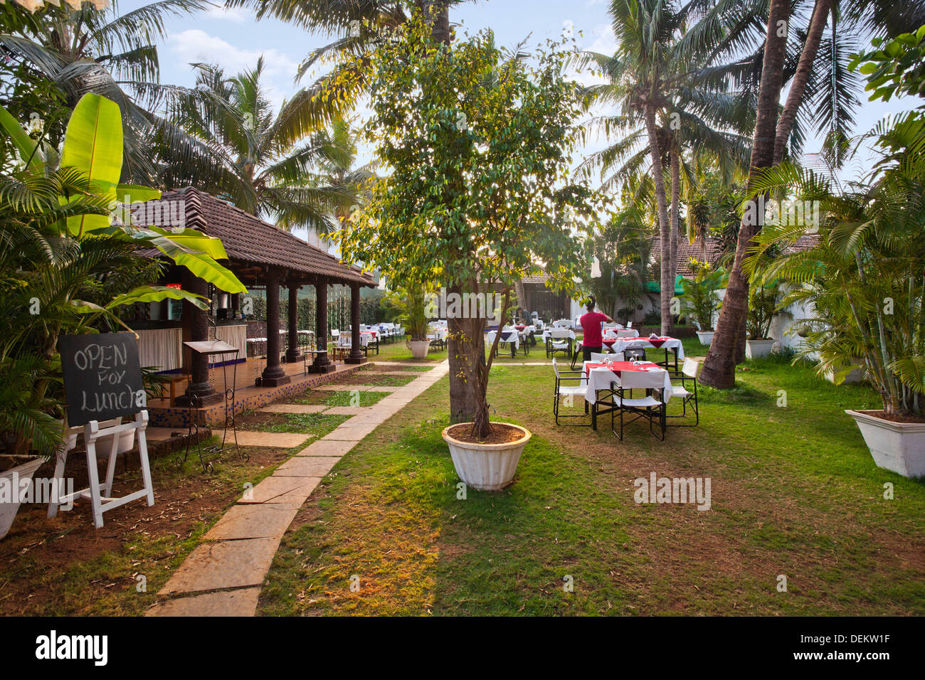 Tables and chairs in a garden restaurant, Le Jardin, Calangute, North Goa, Goa, India Stock Photo