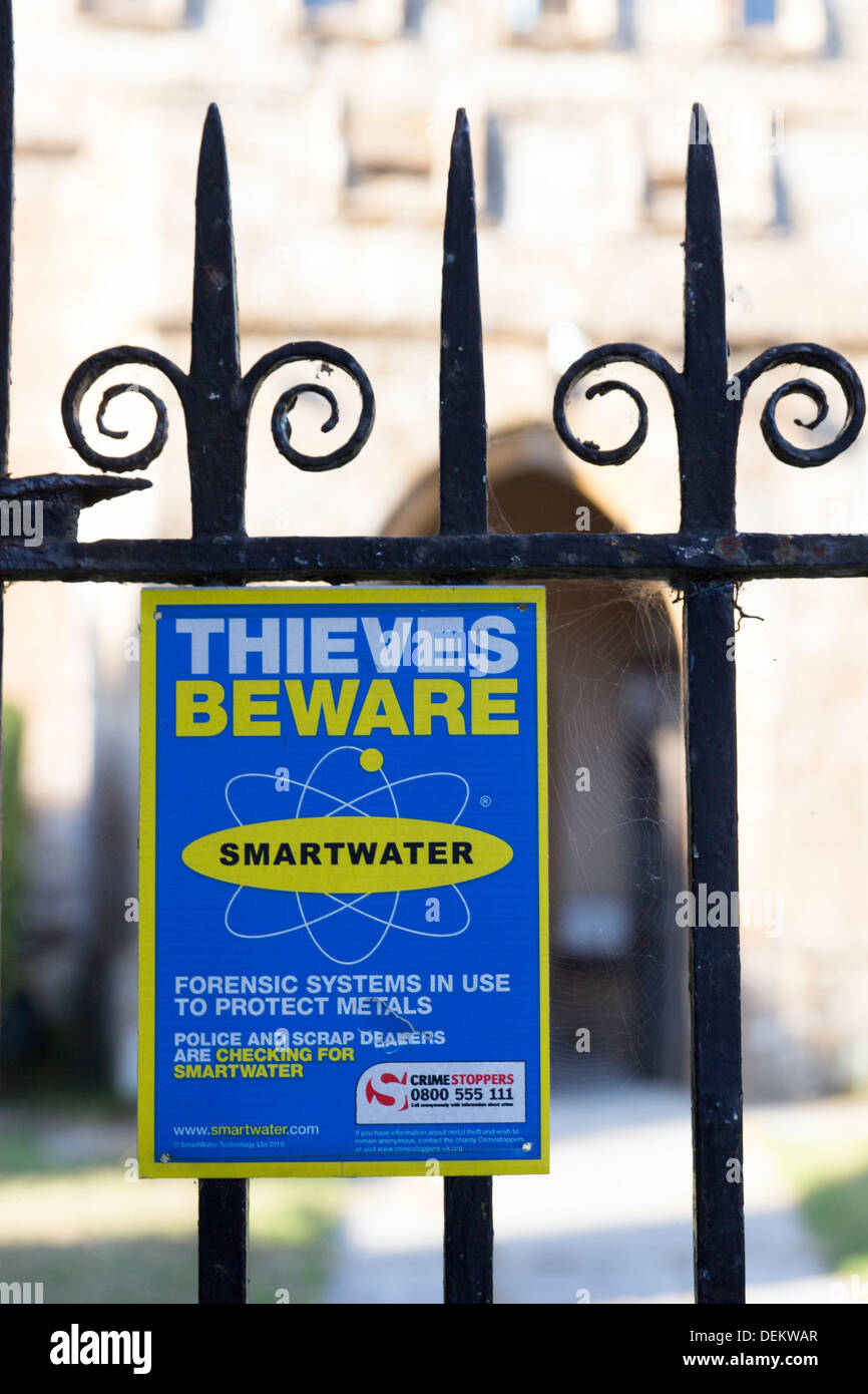A sign warning potential thieves. Blessed Virgin Mary Church, a fifteenth century church in the village of Donyatt in Somerset. Stock Photo