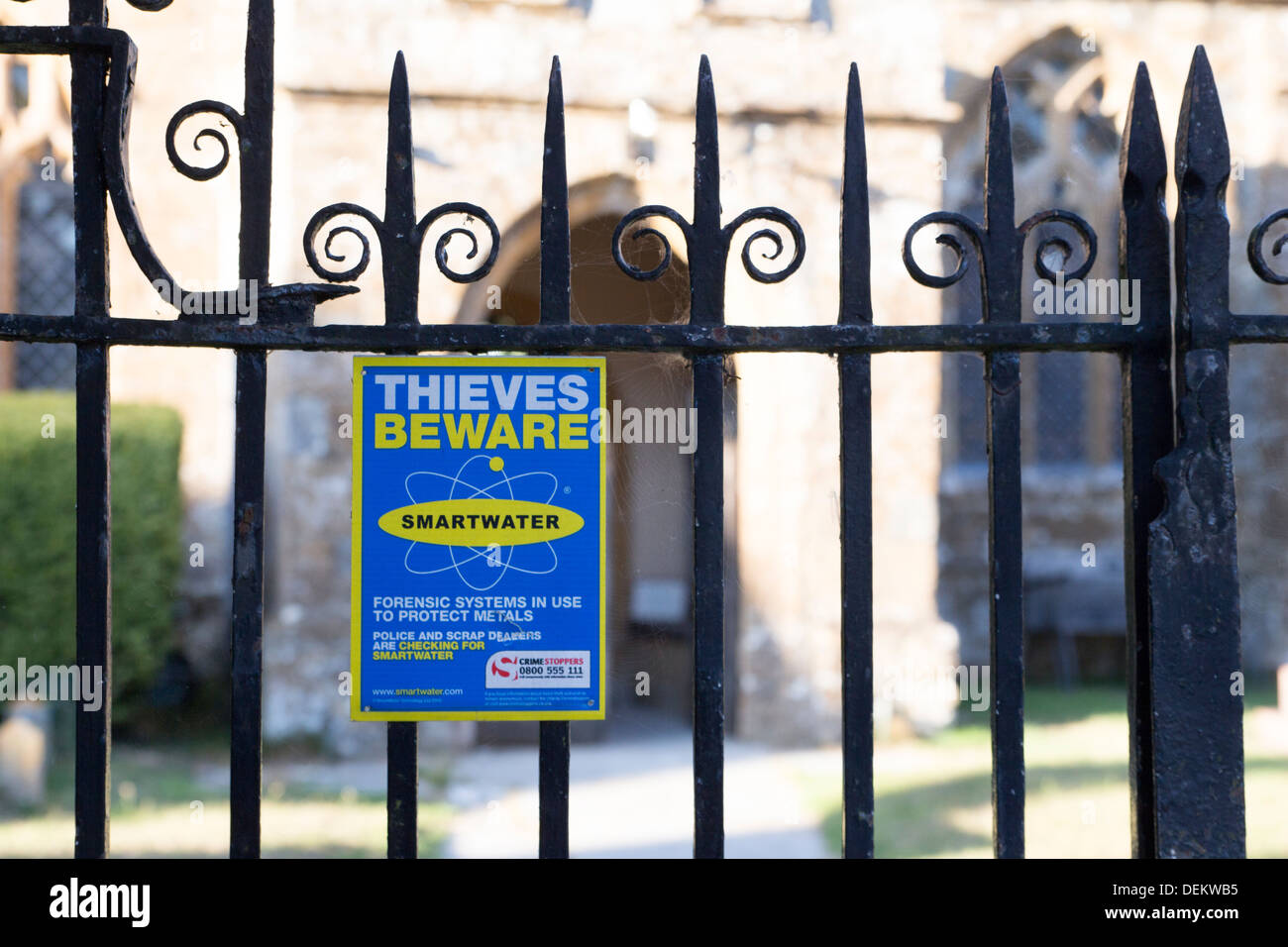 A sign warning potential thieves. Blessed Virgin Mary Church, a fifteenth century church in the village of Donyatt in Somerset. Stock Photo