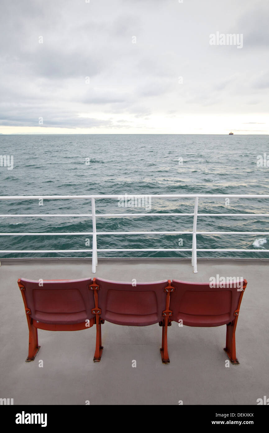 Empty chairs on ferry deck Stock Photo