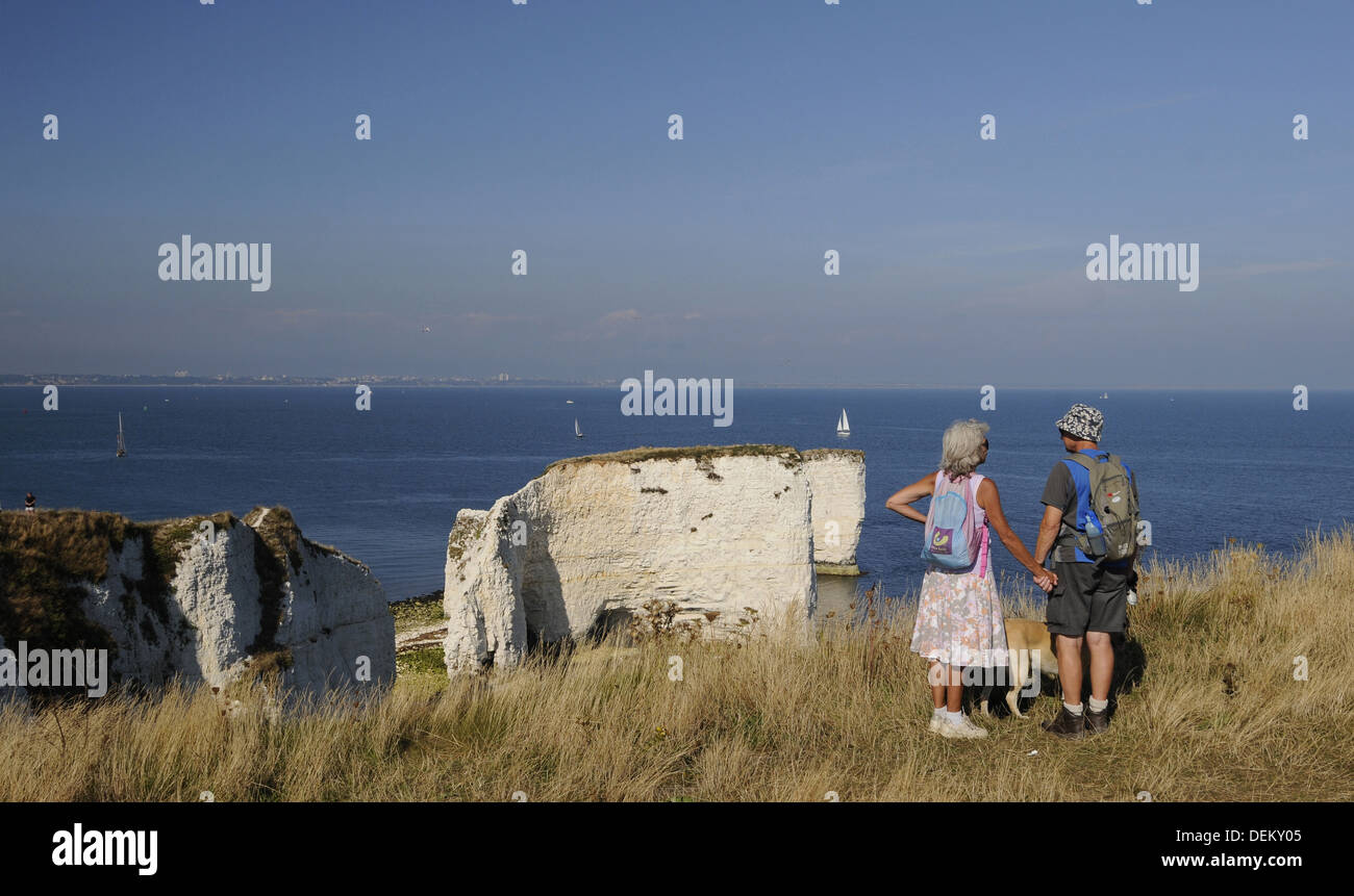Couple with Dog looking over Old Harry Rocks and Poole Bay Jurassic ...