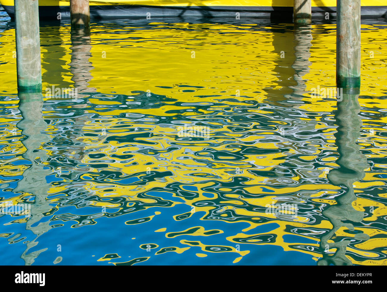 Yellow boat reflected in water Stock Photo