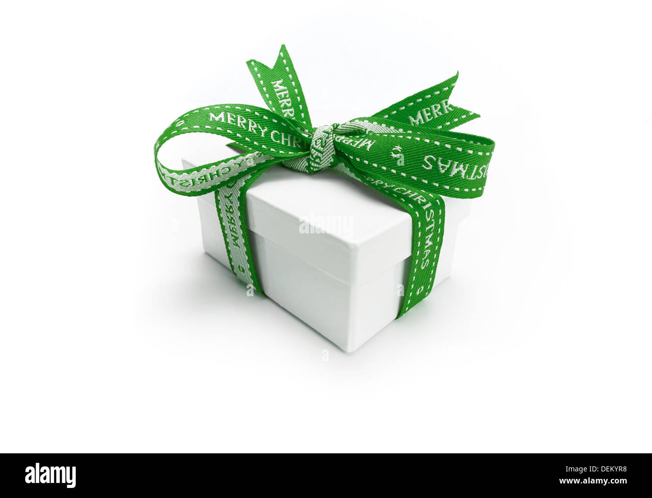 A wrapped Christmas present with a colourful green ribbon and bow on a white background. Stock Photo