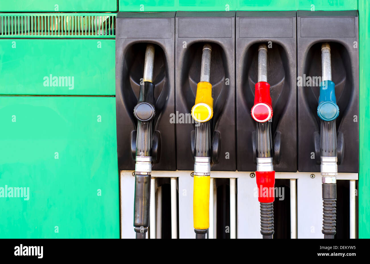 Four gas pump nozzles on the petrol station Stock Photo