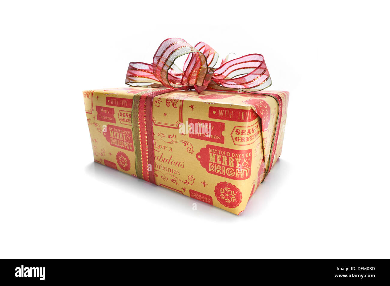 A wrapped Christmas present with a colourful ribbon bow on a white ...