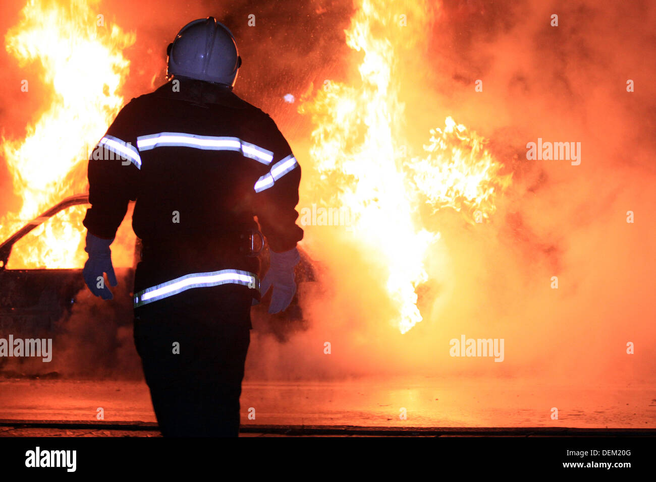 Fireman controlling a huge fire Stock Photo