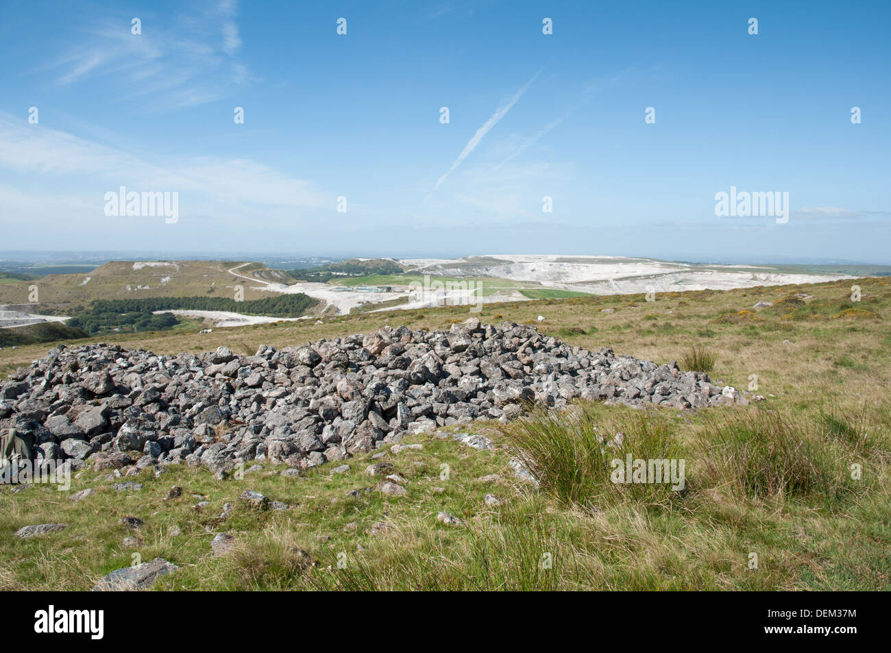 View across cairn towards pits of Lee Moor and Cholwichtown china clay works on south-western edge of Dartmoor. Stock Photo