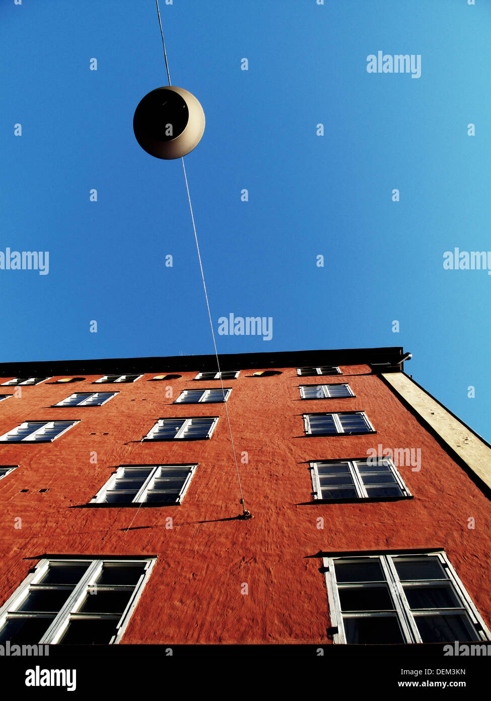 Streetlamp Hanging From Building, Low Angle View Stock Photo