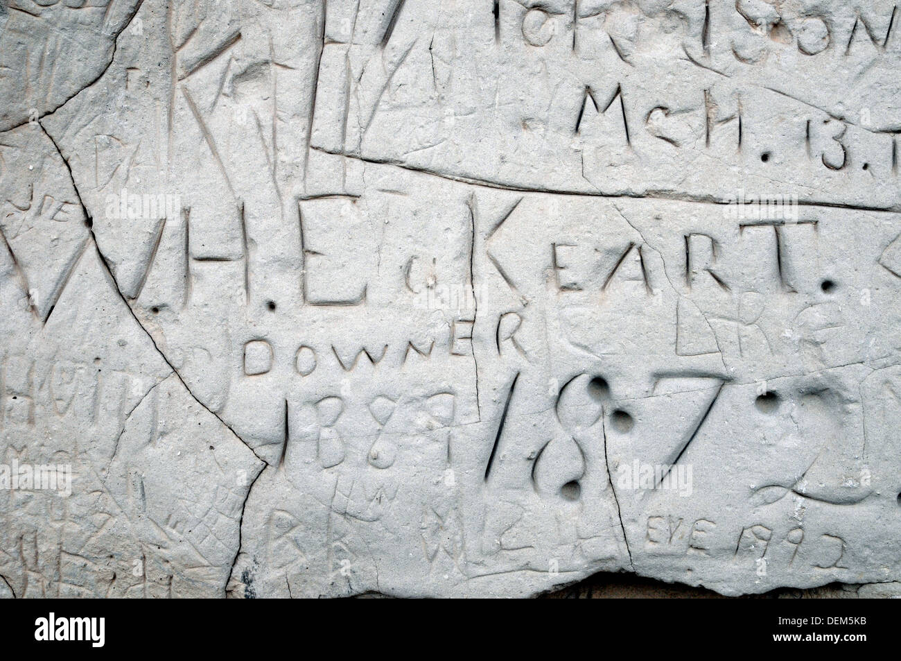 The name of an 700 carved their names hemigrant and user of the Oregon Trail carved into the soft sandstone at Register Cliff, near Guernsey, Wyoming. Stock Photo