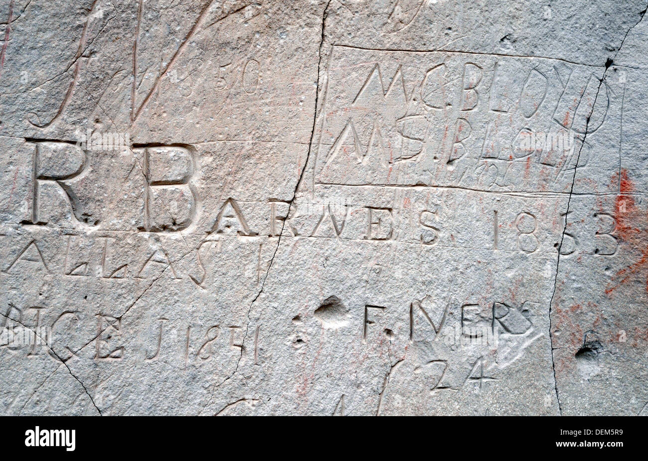 The name of an 700 carved their names hemigrant and user of the Oregon Trail carved into the soft sandstone at Register Cliff, near Guernsey, Wyoming. Stock Photo
