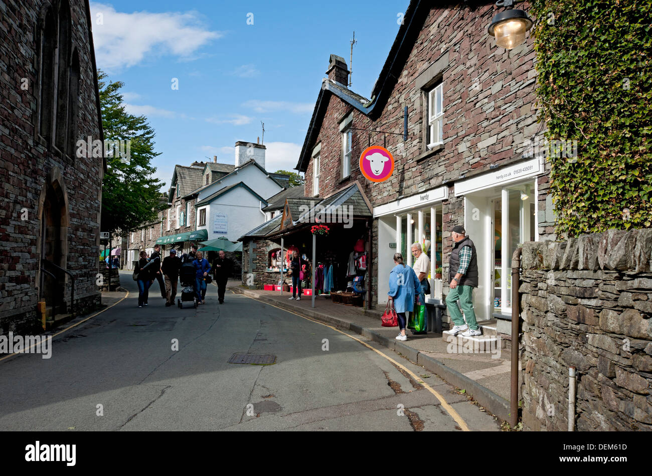 People tourists visitors walking around Grasmere village in summer