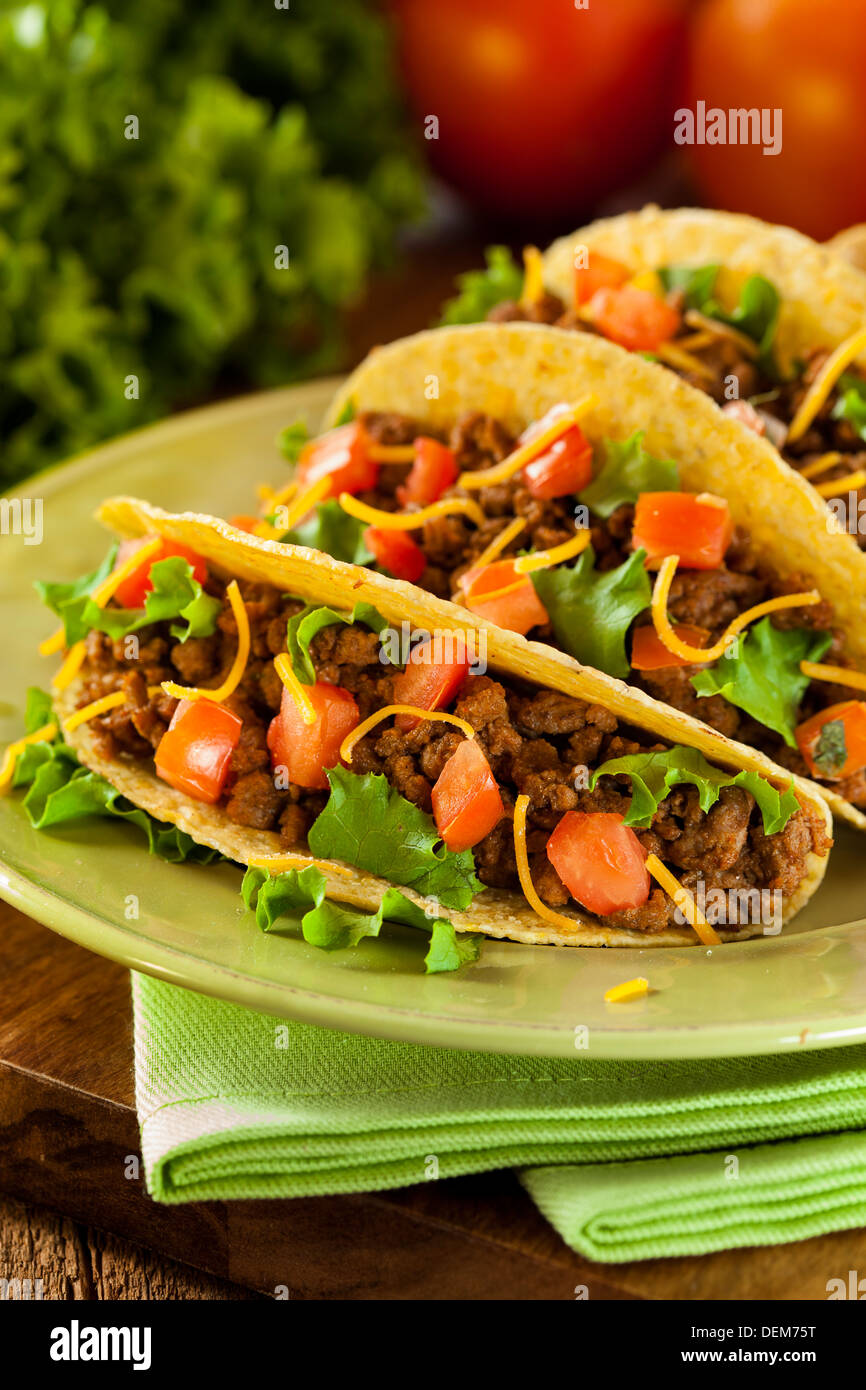 Homemade Ground Beef Tacos with Lettuce, Tomato, and Cheese Stock Photo