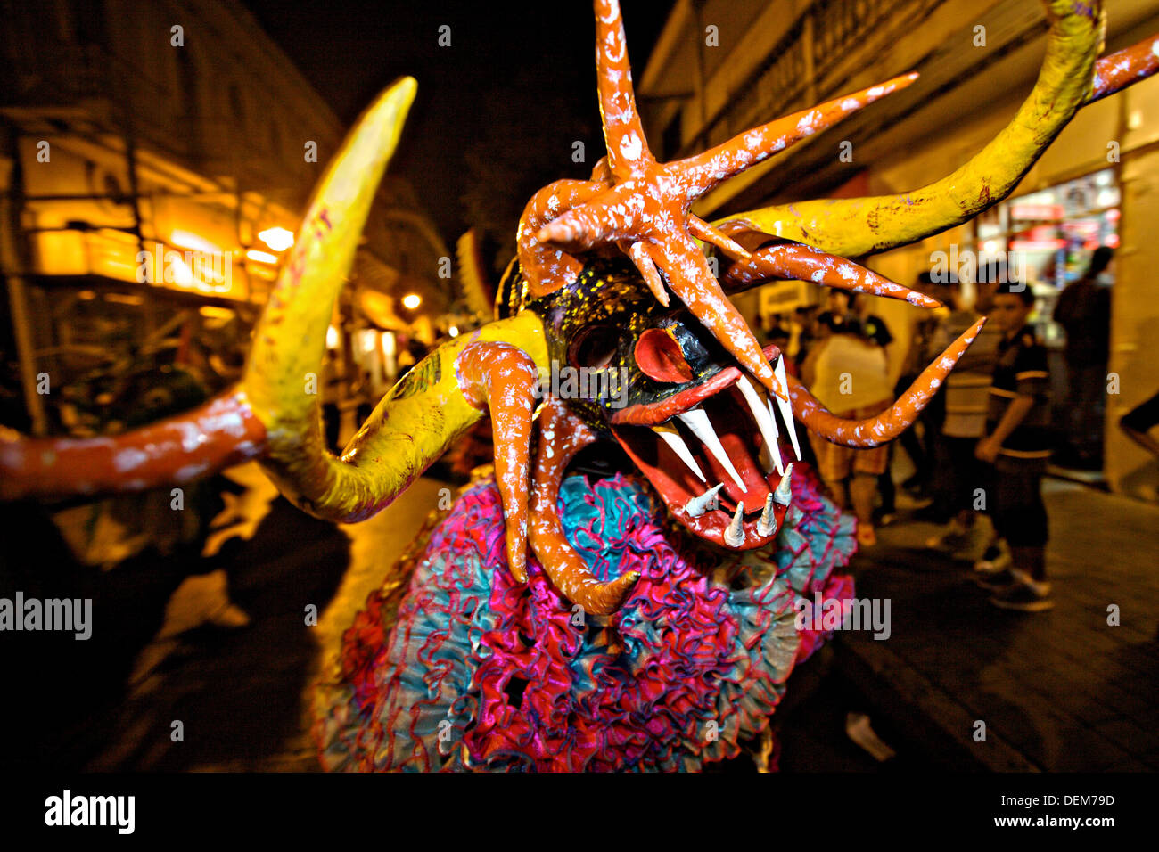 A costumed reveler called vejigante dances in the streets during the Carnaval de Ponce February 21, 2009 in Ponce, Puerto Rico. Vejigantes are a folkloric character representing the devil. Stock Photo