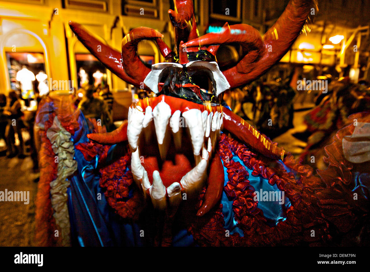 A costumed reveler called vejigante dances in the streets during the Carnaval de Ponce February 21, 2009 in Ponce, Puerto Rico. Vejigantes are a folkloric character representing the devil. Stock Photo
