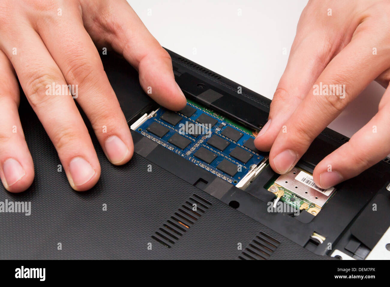Man installing memory. Laptop RAM upgrade Stock Photo - Alamy