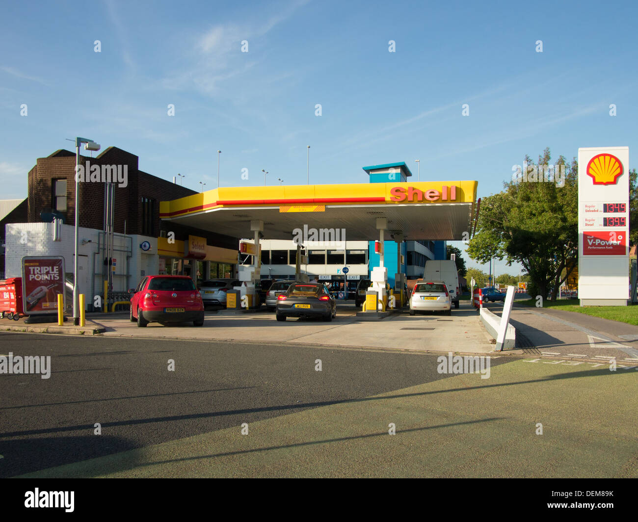 A roadside Shell, self service petrol station within the UK, with cars filling up with fuel in the forecourt. Stock Photo